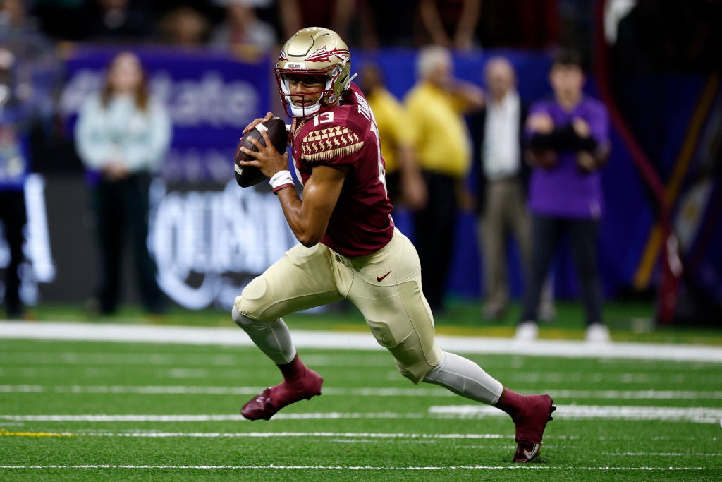 Quarterback Jordan Travis #13 of the Florida State Seminoles looks to throw a pass during a game.