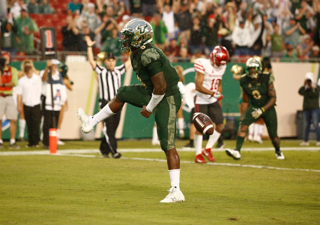 Quarterback Quinton Flowers #9 of the South Florida Bulls celebrates a touchdown run against the Houston Cougars.